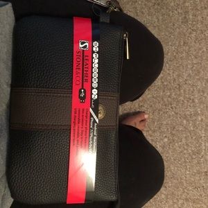 Wristlet with phone charger inside